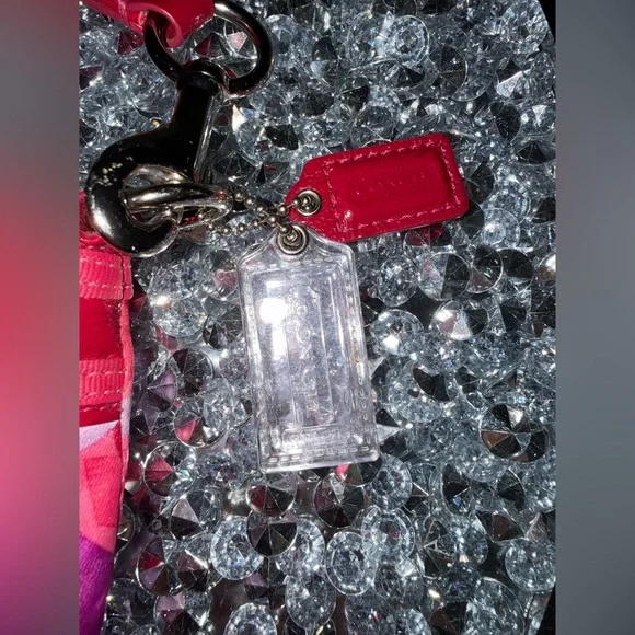 Coach Poppy Wristlet featuring a pink and purple geometric pattern. - Picture 3 of 9